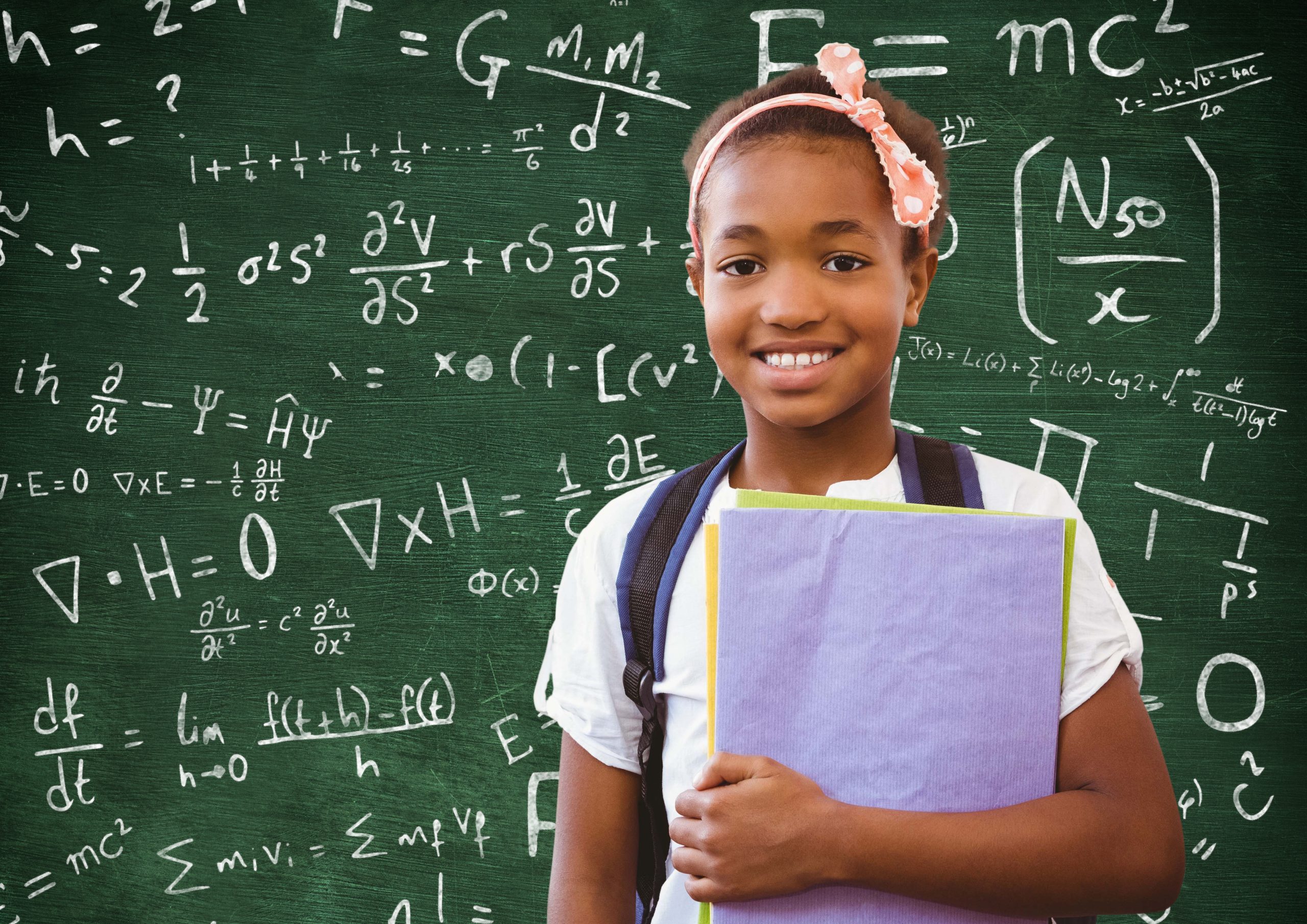 Girl in backpack holding file standing against chalkboard with mathematical symbols and formula